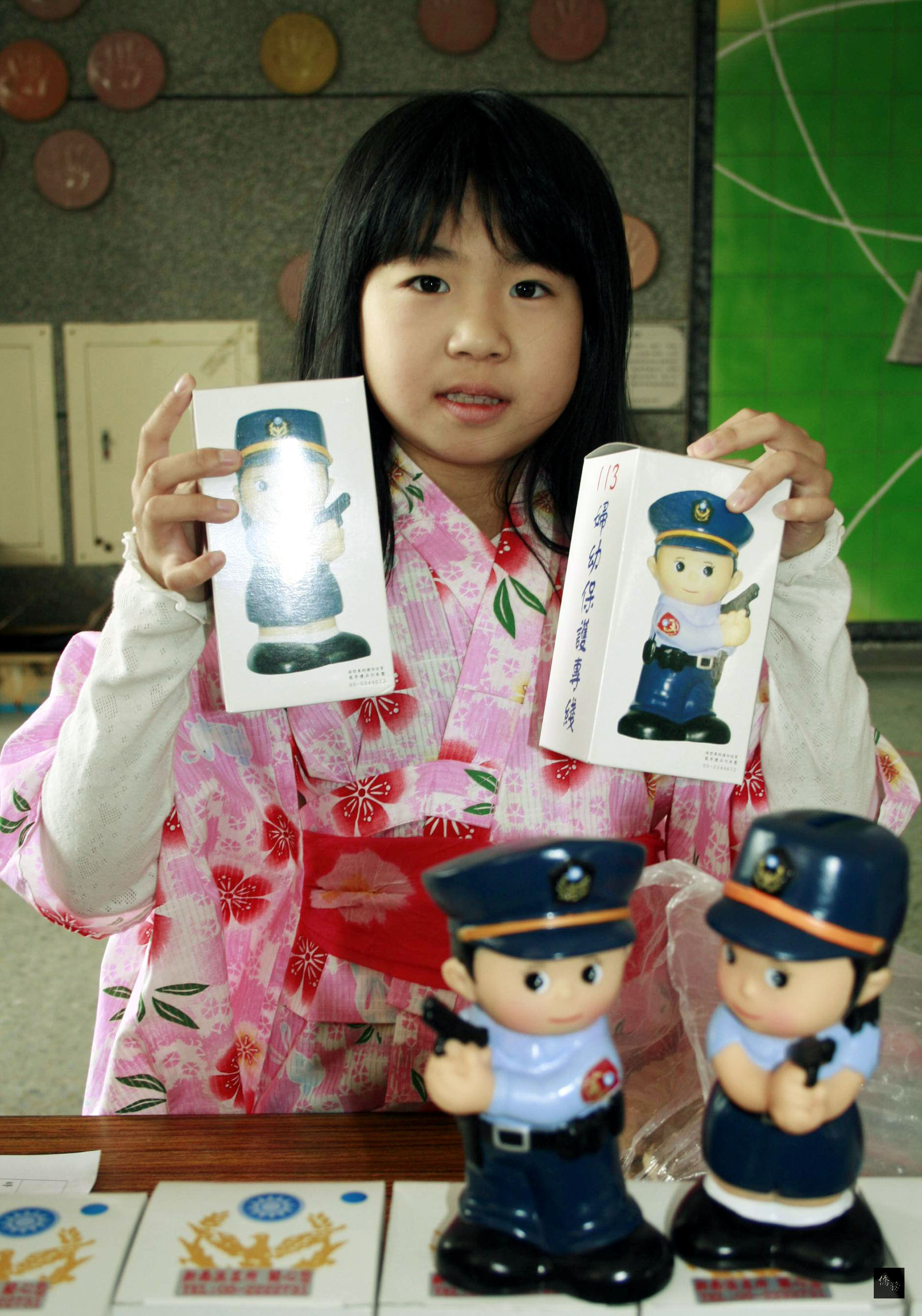 陳櫻子，拿出心愛的警察公仔撲滿義賣，由善心的家長以新台幣1萬元購得。（中央社提供）