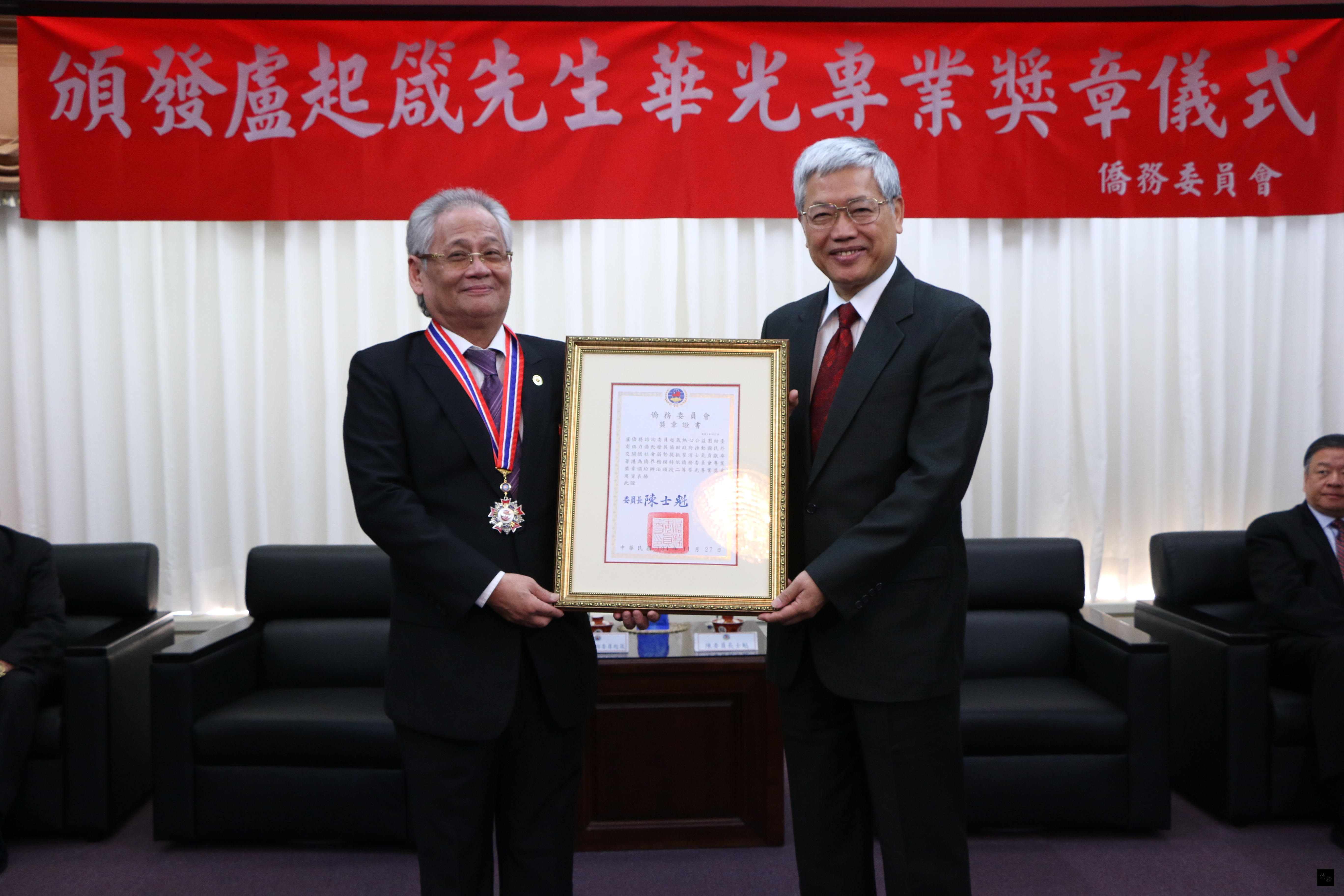 為感謝南非僑務諮詢委員盧起箴(左)熱心公益、團結台商,並致力僑教工作不遺餘力,僑務委員會委員長陳士魁(右)特頒贈二等華光專業獎章予盧起箴。