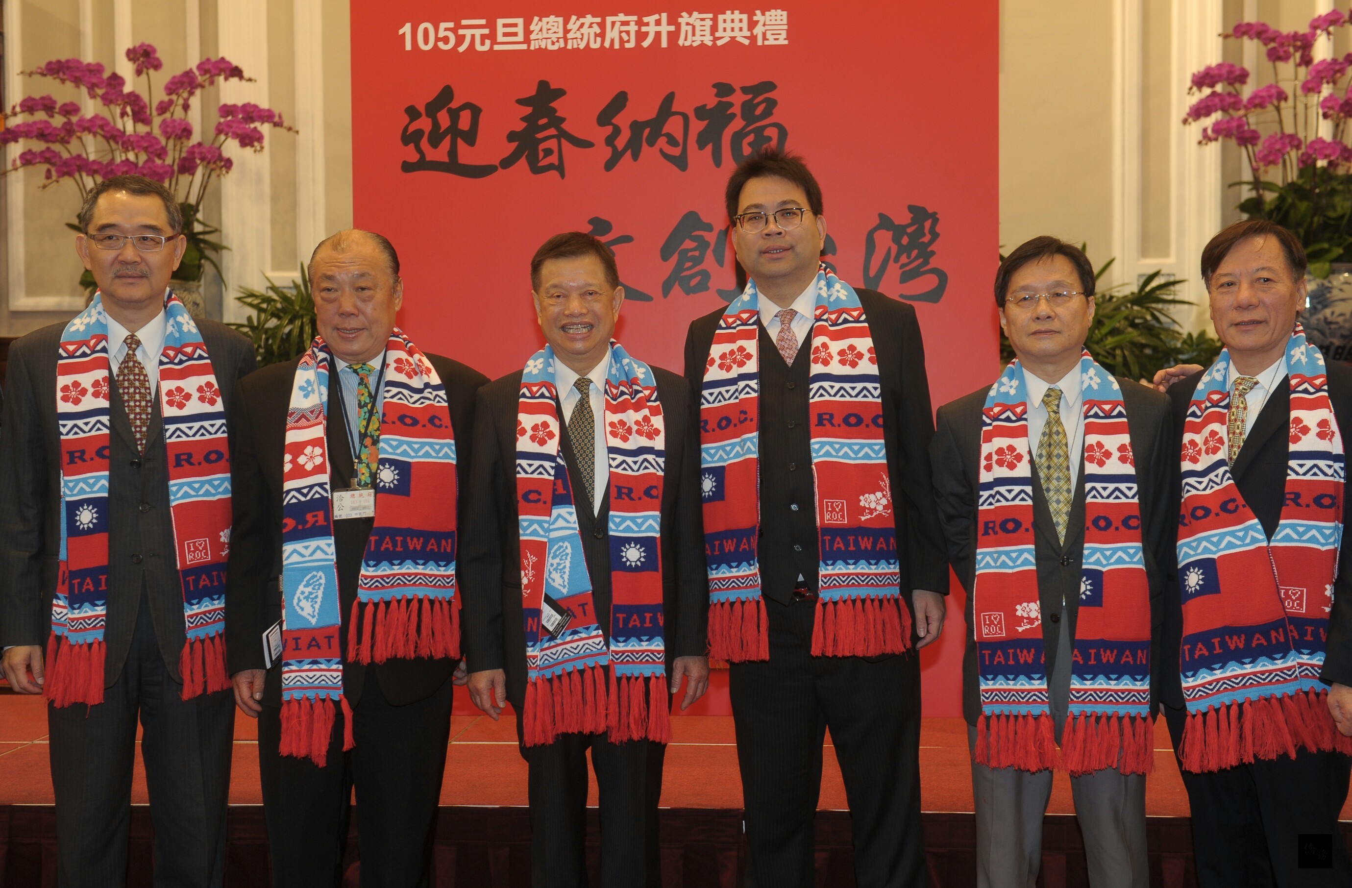 中華民國105年總統府元旦升旗典禮記者會,8日在總統府大禮堂舉行,中華民國工商建設研究會成員一字排開,展示元旦文創展品國旗圍巾。(中央社提供)