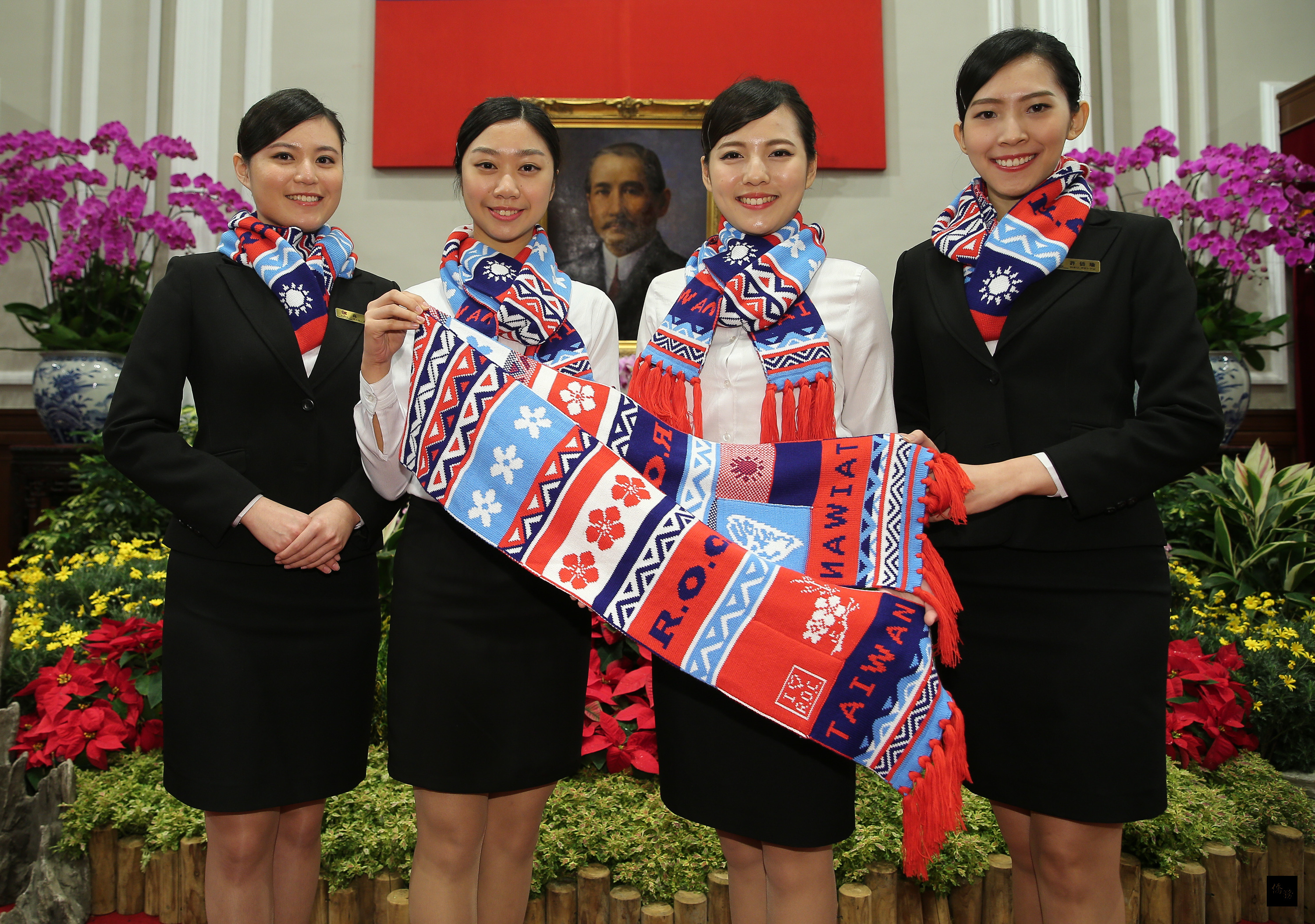 「中華民國105年總統府元旦升旗典禮」記者會28日在總統府舉行,國立台北教育大學的金釵現場展示新款國旗圍巾。(中央社提供)