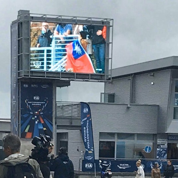 首屆「賽車世運會」在義大利落幕,台灣代表隊雖無緣登上頒獎台,但僑胞揮舞國旗的畫面獲得轉播單位大螢幕特寫,讓中華民國國旗意外登上國際舞台。(中央社提供)