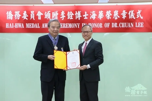 吳新興(右)親自頒贈海華榮譽章予李銓(左)。