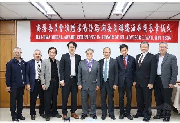 2019年2月27日，在僑委會前委員長吳新興（右4）、立法委員邱志偉（左4）及僑務榮譽職人員共同見證下，梁輝騰（中）受頒海華榮譽章。