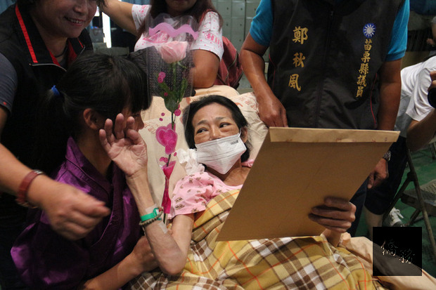 苗栗縣後龍國小扯鈴隊曾獲世界冠軍，當時主要成員升國中後，18日難得合體為其中一名同學的癌末母親張秀妹（前右）進行「特別演出」。表演結束後，張秀妹女兒（前左）走到她身邊說「媽媽加油！」張秀妹也吃力舉起手，輕撫女兒臉頰拭淚，告訴她「妳最棒」，場面溫馨，令人動容。（中央社提供）