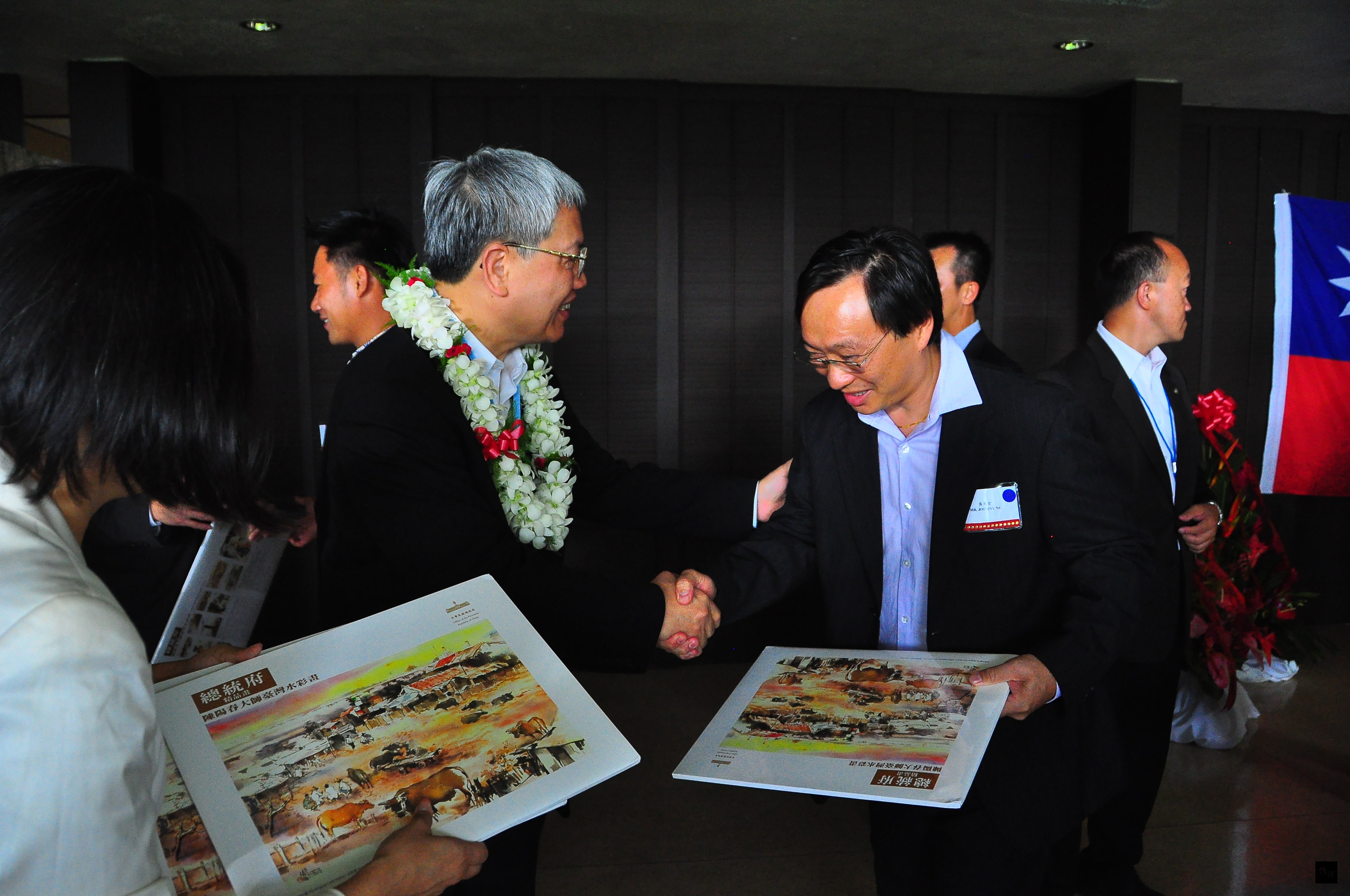 僑委會委員長陳士魁代表總統馬英九致贈台灣水彩畫冊給僑胞陳陽春。（駐檀香山辦事處提供）