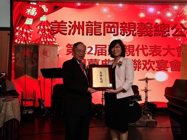 徐詠梅(右)代表陳文儀致贈美洲龍岡親義總公所代表獎牌。