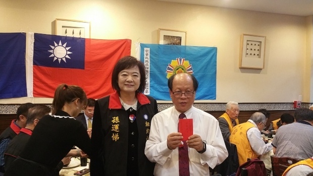 中國國民黨駐美東支部常委孫運悌（左）攜帶禮金、高粱酒與鳳梨酥，出席紐澤西榮光會「國慶暨榮民節晚會」，理事長張淵源（右）代表接受。（世界日報提供）