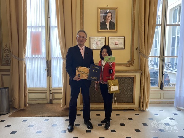 駐法國代表處大使吳志中（左）頒發僑務榮譽職人員聘書予僑務促進委員林寶寶（右）。