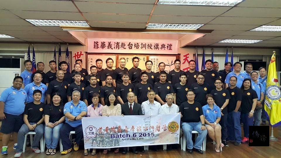 菲華文教中心主任吳學誠、菲華文經總會常務委員王家鵬與2015年菲華僑商青年消防研習營學員，在授旗儀式中合影。（菲華文教中心提供）
