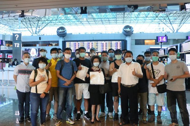 何素珍與搭乘專機的臺灣鄉親合影。