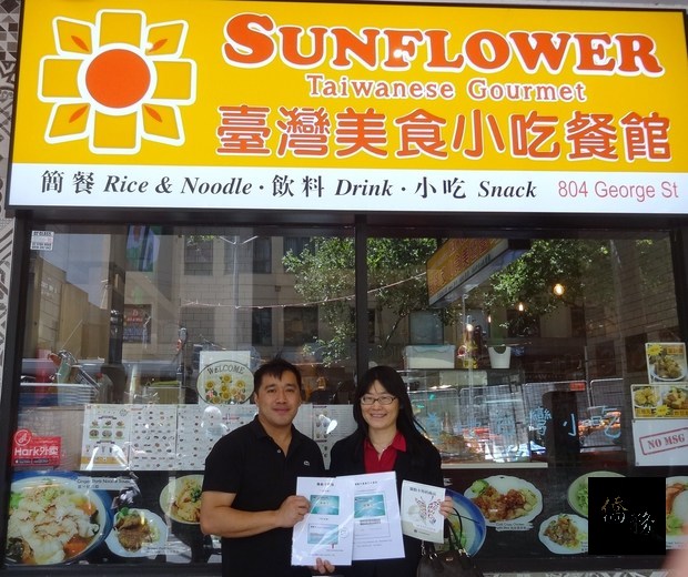 吳春芳(右)頒發僑胞卡特約商店識別貼紙予業者(左)。