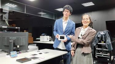 Wu Chun-guey, right, and Chen Chia-yuan yesterday pose with a photovoltaic cell in the center’s laboratory at National Central University in Taoyuan.  / Photo courtesy of Taipei Times