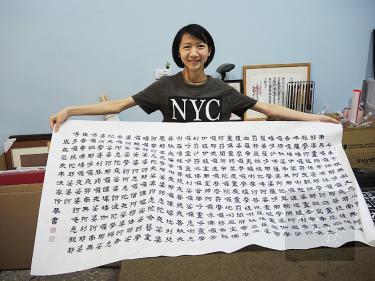 Calligrapher Wang Chia-ling displays some of her work in Taoyuan on Friday last week./Photo courtesy of Taipei Times