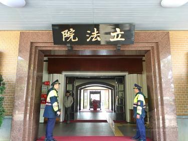 Police officers guard an entrance at the Legislative Yuan in Taipei on Jan. 28 last year. / Photo courtesy of Taipei Times