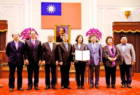President Tsai Ing-wen, fourth right, holds the Special Act on COVID-19 Prevention, Relief and Restoration that she signed yesterday at the Presidential Office in Taipei./Photo courtesy of Taipei Times