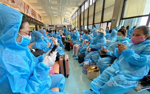 Passengers in the departure lounge before boarding the flight back to Vietnam.