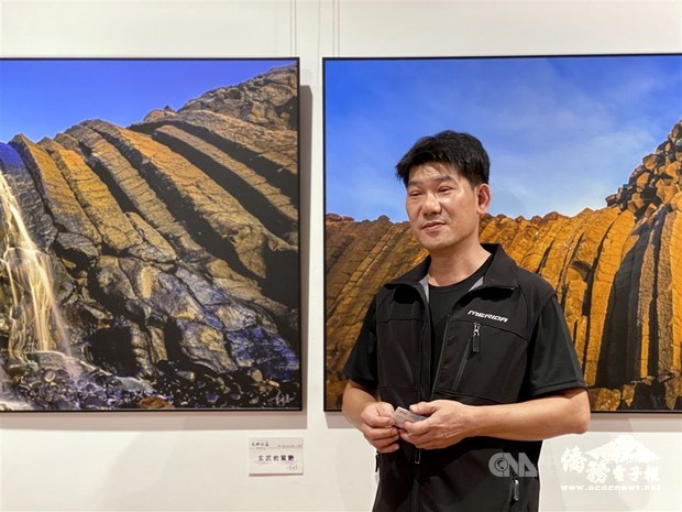 Taiwanese photographer Lee Ming-tsung (李明宗) stands besides his works exhibited at National Dr. Sun Yat-sen Memorial Hall in Taipei / Photo courtesy of CNA