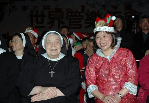 嘉義市聖馬爾定醫院創辦人兼董事長華淑芳修女（前左），來台逾一甲子奉獻醫療，出版新書「愛的腳蹤」，市長黃敏惠（前右）出示2007年與華修女合照。（嘉義市政府提供）